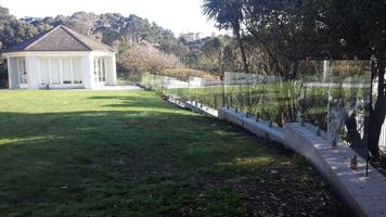 Finished Palisade Wall With Concrete Capping Beam And Glass Balustrade