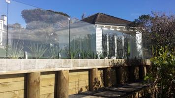 Timber Retaining Wall With Concrete Capping Beam And Glass Balustrade